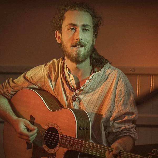 William Goan playing guitar